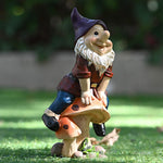 Garden Gnome Sits On Mushroom Decoration
