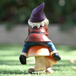 Garden Gnome Sits On Mushroom Decoration