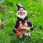 Garden Gnome Sits On Mushroom Decoration