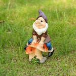 Garden Gnome Sits On Mushroom Decoration