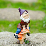 Garden Gnome Sits On Mushroom Decoration