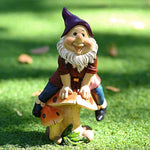 Garden Gnome Sits On Mushroom Decoration