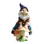 Garden Gnome Sits On Mushroom Decoration