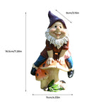 Garden Gnome Sits On Mushroom Decoration